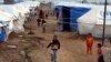 Displaced Iraqi children, who fled from Islamic State violence in Mosul, play in refugee camp on the outskirts of the Kurdish city of Irbil, December 1, 2014.