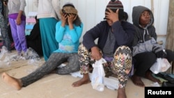 Migrants are seen at a naval base after being rescued by the Libyan coast guard in Tripoli, Libya, March 10, 2018. Hundreds of migrants were picked up trying to cross the Mediterranean to Italy.