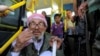 Passengers board a bus awaiting evacuation from the besieged Damascus suburb of Daraya, Aug. 26, 2016, following an agreement between rebels and Syria's government.