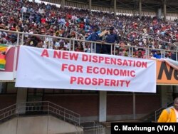 Supporters of President Emmerson Mnangagwa display a banner in Harare, April 18, 2018, showing what the new government is promising Zimbabweans.