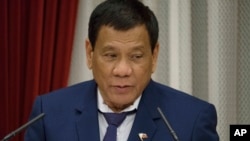 FILE - Philippine President Rodrigo Duterte delivers a speech at the start of a banquet hosted by Japanese Prime Minister Shinzo Abe in Tokyo, Oct. 30, 2017.