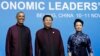 U.S. President Barack Obama, left, poses for photographs with China's President Xi Jinping, center, and Xi's wife, Peng Liyuan, during the APEC Welcome Banquet at Beijing National Aquatics Center in Beijing, Nov. 10, 2014. 