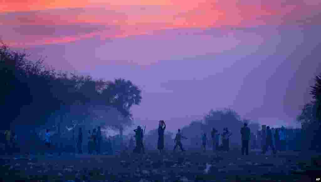 Displaced people, who fled the recent fighting between government and rebel forces in Bor by boat across the White Nile, prepare to sleep in the open at night in the town of Awerial, South Sudan, Jan. 1, 2014.