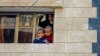 Children look at the scene of an explosion in Sana'a, Yemen, Jan. 22, 2015.