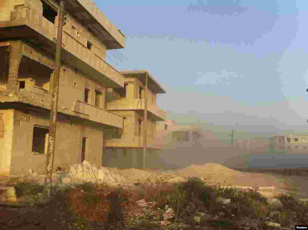 Smoke is seen after a Syrian Air Force fighter jet loyal to Syria's President Bashar al-Assad fired missiles at Taftanaz near Idlib, Syria, November 4, 2012.