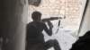 FILE - This undated file photo posted Nov. 4, 2014 by the Raqqa Media Office of the Islamic State group, a militant extremist group, shows an Islamic state group fighter in Kobani, Syria. 