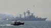 A Turkish Navy cost guard boat (L) escorts the Russian Navy destroyer Smetlivy, in the Bosphorus in Istanbul, July 11, 2012. 