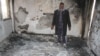 A man inspects his house that was damaged during recent clashes between armed factions in Tripoli's Abu Selem district, Libya, March 1, 2017. 