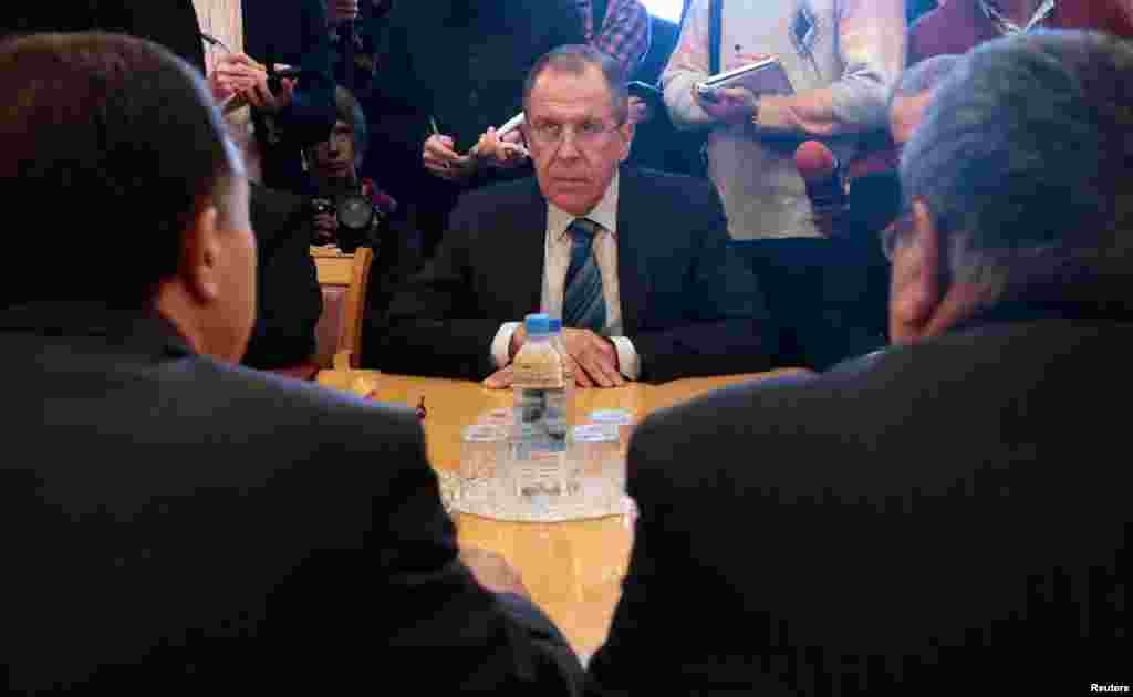 Russian Foreign Minister Sergei Lavrov (center) meets with Haitham Manna, the president of the National Coordination Body for Democratic Change in Syria, front left, and secretary Raja al-Nasser, front right, in Moscow, March 11, 2013.