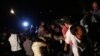 Rescue workers carry a body from a collapsed residential building in Thane, on the outskirts of Mumbai, April 4, 2013. 