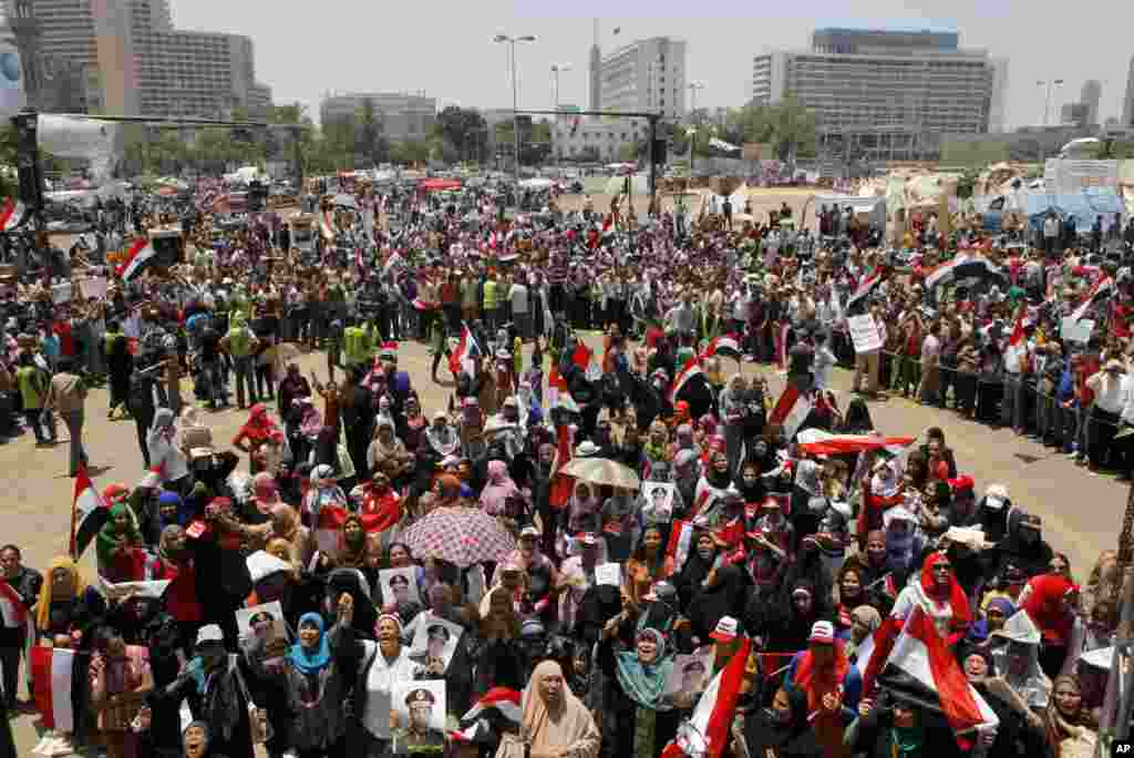 Opponents of Egypt&#39;s ousted president Mohamed Morsi wave national flags and posters showing Lt. Gen. Abdel-Fattah el-Sissi in Tahrir Square, in Cairo, Egypt, Friday, July 5, 2013. Egypt&#39;s Muslim Brotherhood called for a wave of protests Friday, furious o