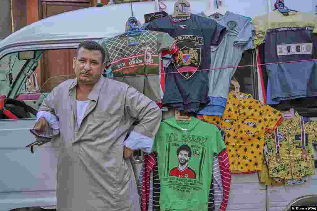 Salah donates money to projects in Nagrig, but his image also yields riches for local vendors who have been doing brisk business in the runup to the World Cup. Familiarity sells. “I have known Mohamed Salah since he was 10 a year-old boy." says a street vendor. "He was always a polite and and decent child and that is why I am super excited to be selling T-shirts with his photos and name.”
