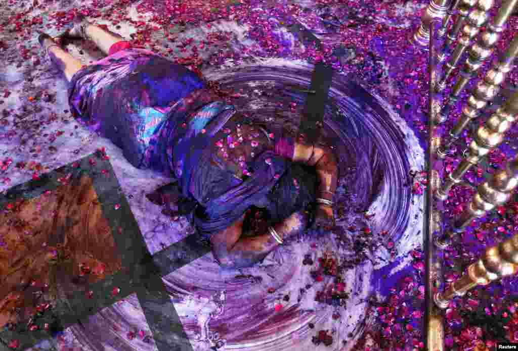 A Hindu woman prays while lying on the floor of a temple during Holi celebrations in the western Indian city of Ahmedabad. Holi, also known as the Festival of Colors, heralds the beginning of spring and is celebrated all over India.