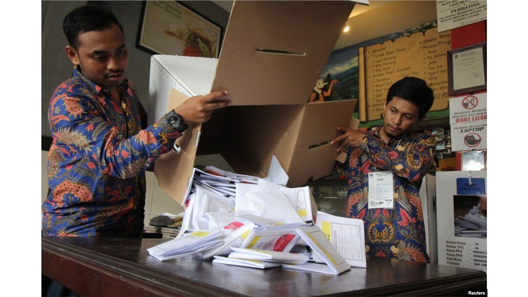 Electoral officials count ballots at a polling center during elections in Surabaya, East Java province, Indonesia, April 17, 2019 in this photo taken by Antara Foto.