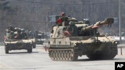 South Korean army K-55 self-propelled howitzers move during an exercise against possible attacks by North Korea in Pocheon, South Korea, near the border with North Korea, March 27, 2013. 
