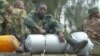 An M23 soldier rests on boxes of ammunition as the group withdraws from the Congolese city of Goma, Dec. 1, 2012 (photo - VOA/G. Joselow).