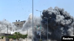 Smoke rises during what witnesses said was an explosion caused by an Israeli air strike on a house in Gaza City, Aug. 23, 2014. 
