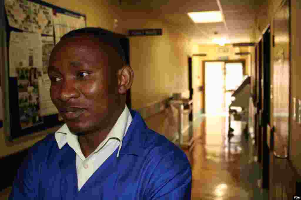 A Deipkloof staff member silently passes rooms where small changes occur in a patient's breathing as death approaches. "That is the death rattle," said one caregiver. (VOA / D. Taylor)