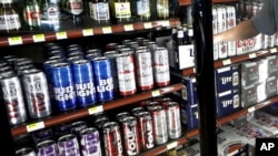 FILE - This April 19, 2017 file photo shows the beer cooler behind the counter in a convenience store in Sheridan, Indiana. In future sweltering years with a double whammy of heat and drought, losses of barley yield can be as much as 17 percent, computer simulations show. And that means “beer prices would, on average, double,” even adjusting for inflation, said a study published in the journal Nature Plants on Oct. 17, 2018.