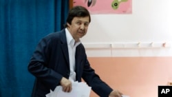 FILE - Said Bouteflika, brother of then-Algerian President Abdelaziz Bouteflika, prepares to vote in Algiers, May 4, 2017. Said Bouteflika was detained May 4, 2019, for questioning along with two generals who previously ran state security agencies, a security official said. 