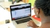 A woman looks at a Ushahidi website set up to monitor Kenya's national election earlier this year. (J. Craig/VOA)
