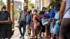 Evacuees from Lake Charles, Louisiana, and surrounding areas are seen outside a hotel in New Orleans, Louisiana, Aug. 28, 2020. The state government has requested hotels make rooms available for those affected by Hurricane Laura.