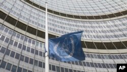 A flag is set to half mast in front of the International Atomic Energy Agency (IAEA) building in Vienna, Austria, Monday, July 22, 2019. The IAEA announced the death of the agency's Director General Yukiya Amano at the age of 72 years. (AP Photo…