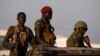 FILE - SPLA soldiers stand in a vehicle in Juba.