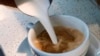 FILE - A barista pours steamed milk in a coffee at a cafe in Los Angeles, California, Sept. 22, 2017. 