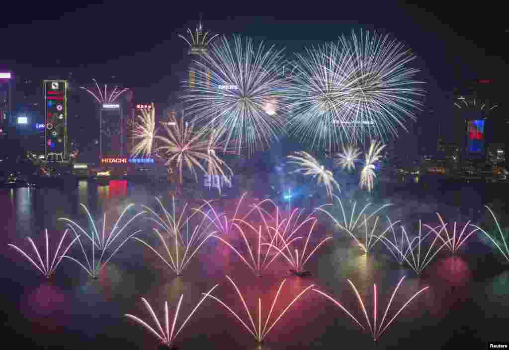 Fireworks explode over Victoria Harbour and Hong Kong Convention and Exhibition Centre during a pyrotechnic show to celebrate the new year in Hong Kong.