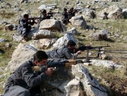 FILE - Recruits of PJAK, the Party for a Free Life in Kurdistan, a splinter group of the PKK, the Kurdistan Workers' Party, take defensive positions near the PJAK training camp in the Qandil mountain range, northern Iraq.