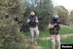 FILE - Egyptian Army officers are seen in the troubled northern part of the Sinai Peninsula during a launch of a major assault against militants, in Al Arish, Egypt, in this undated handout picture made available by the Ministry of Defense, March 4, 2018.