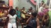 VOA's Victoria Macchi, right foregound, speaks to Damas de Blanco leader Berta Soler, left foreground, in Havana, March 20, 2016.