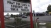 Businesses throughout the town of Santa Fe, Texas, post signs in support of the survivors and the loved ones of those killed in the high school shooting May 18, 2018.