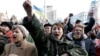 People cheer as they listen to speeches in front of a statue in Independence Square in Kyiv, Feb. 21, 2014.