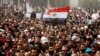FILE - A man holds an Egyptian flag during a rally at Tahrir Square, in Cairo, Feb. 25, 2011. 