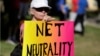 FILE - Lori Erlendsson attends a pro-net neutrality Internet activist rally in the neighborhood where President Barack Obama attended a fundraiser in Los Angeles, California, July 2014.