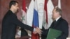 In this Jan. 25, 2005 file photo, Syrian President Bashar Assad, left, and Russian President Vladimir Putin shake hands during a signing ceremony in the Kremlin, Moscow.