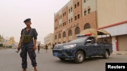 A pro-Houthi police trooper stands past a patrol vehicle in the Red Sea port city of Hodeidah, Yemen, June 14, 2018. 