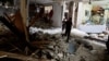 Palestinians check a house damaged during an Israeli raid, in Balata camp, Nablus, in the Israeli-occupied West Bank, May 22, 2023.