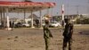 Members of the military stand at the scene of an explosion near a petrol station in Kano, Nigeria, Nov. 15, 2014. 