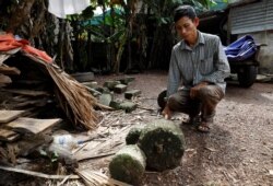 Nguyen Dinh Gia shows a barbell was used by his son Nguyen Dinh Luong, who was found dead in the back of British truck, at home in Ha Tinh province, Vietnam, Oct. 27, 2019.