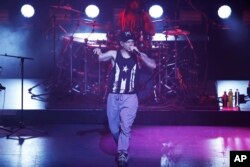 FILE - Singer-songwriter Rene Perez Joglar, also known as Residente, performs during his concert at the Auditorio Nacional in Mexico City, June 17, 2017.