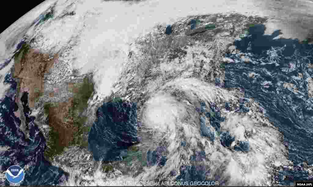This satellite image made available by NOAA shows Hurricane Michael, center, in the Gulf of Mexico, Oct. 9, 2018, at 3:17 p.m. EDT.