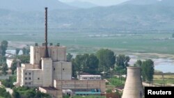 A North Korean nuclear plant is seen before demolishing a cooling tower (R) in Yongbyon, in this photo taken June 27, 2008 and released by Kyodo. North Korea is to restart the mothballed Yongbyon nuclear reactor that has been closed since 2007 in a move t