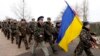 Ukrainian servicemen march away, after negotiations with Russian troops at the Belbek Sevastopol International Airport in the Crimea region, March 4, 2014. 