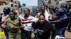 Ugandan police officers detain protestors during a rally against what the protesters say are rampant corruption and human rights abuses by the country's rulers in Kampala, Uganda, July 23, 2024. 