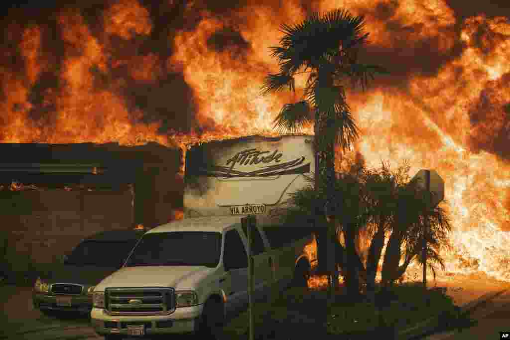 Flames consume a home on Via Arroyo as a wildfire rages in Ventura, Dec. 5, 2017.