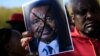 People protest Cameroon's President Paul Biya on Pennsylvania Avenue near the White House, Oct. 22, 2018 in Washington. On Saturday protesters marched and sang on the streets in Douala and other cities.