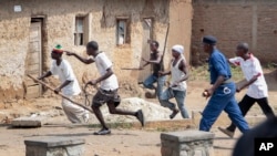 Des membres de la milice pro-gouvernementale Imbonerakure poursuivent les manifestants de l'opposition dans le district de Kinama, Bujumbura, Burundi, le 25 mai 2015.